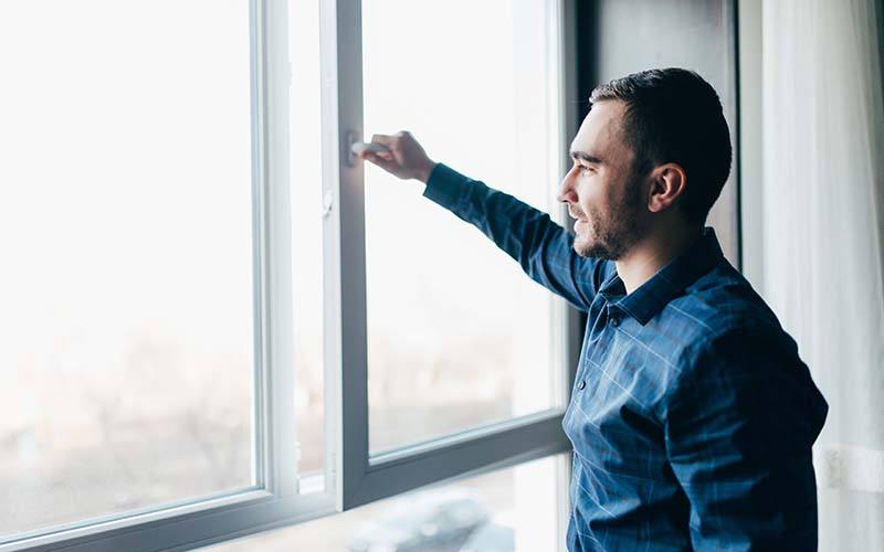 Handsome Man Is Opening The Window At Home To Refresh The Room