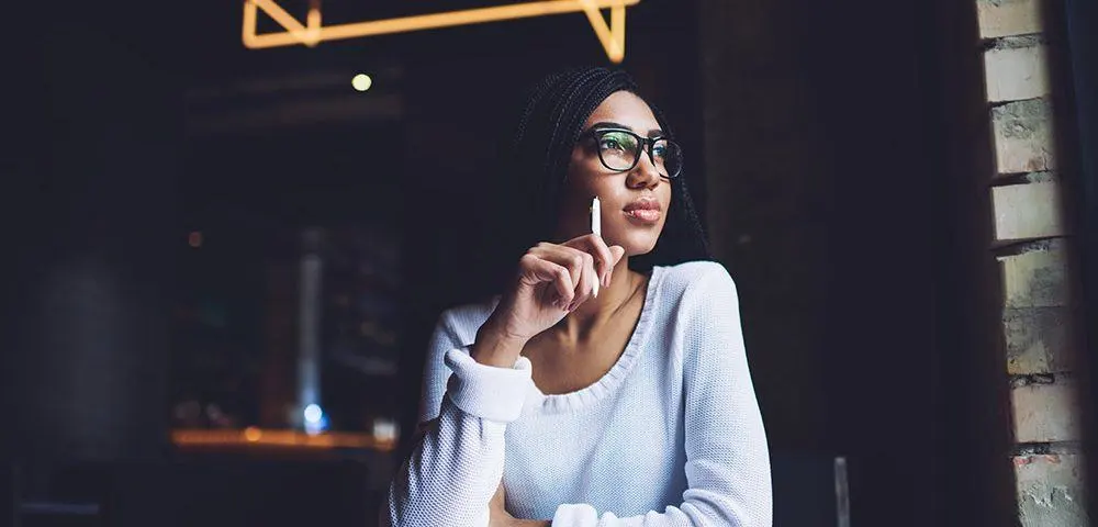 Frau muss Entscheidung treffen und schaut aus dem Fenster